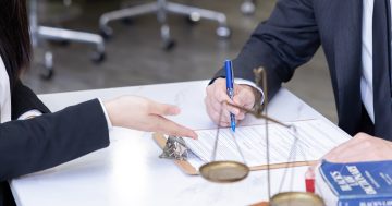 image of lawyer guiding and managing the documentation of legal papers