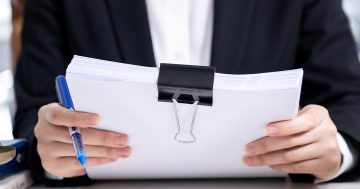 image of a lawyer holding a stack of legal documents