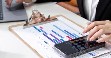 Lawyer calculating the timeline of a case on a spreadsheet and calculator