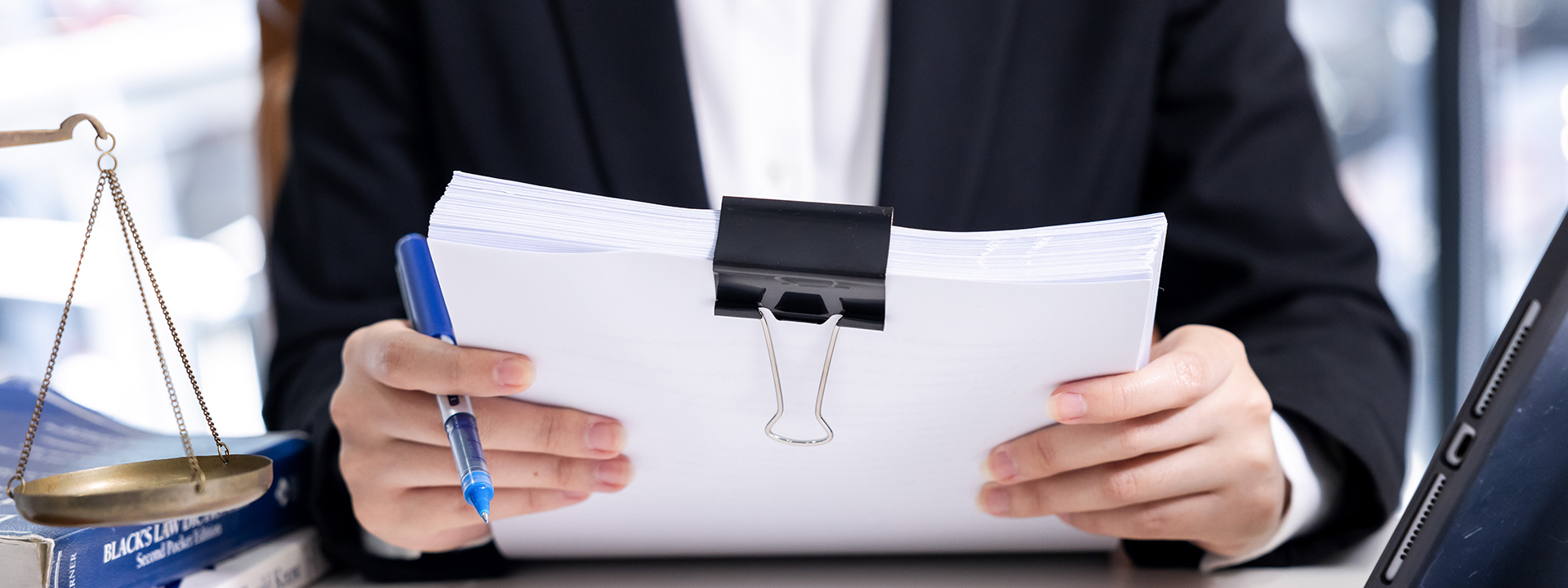 image of a lawyer holding a stack of legal documents